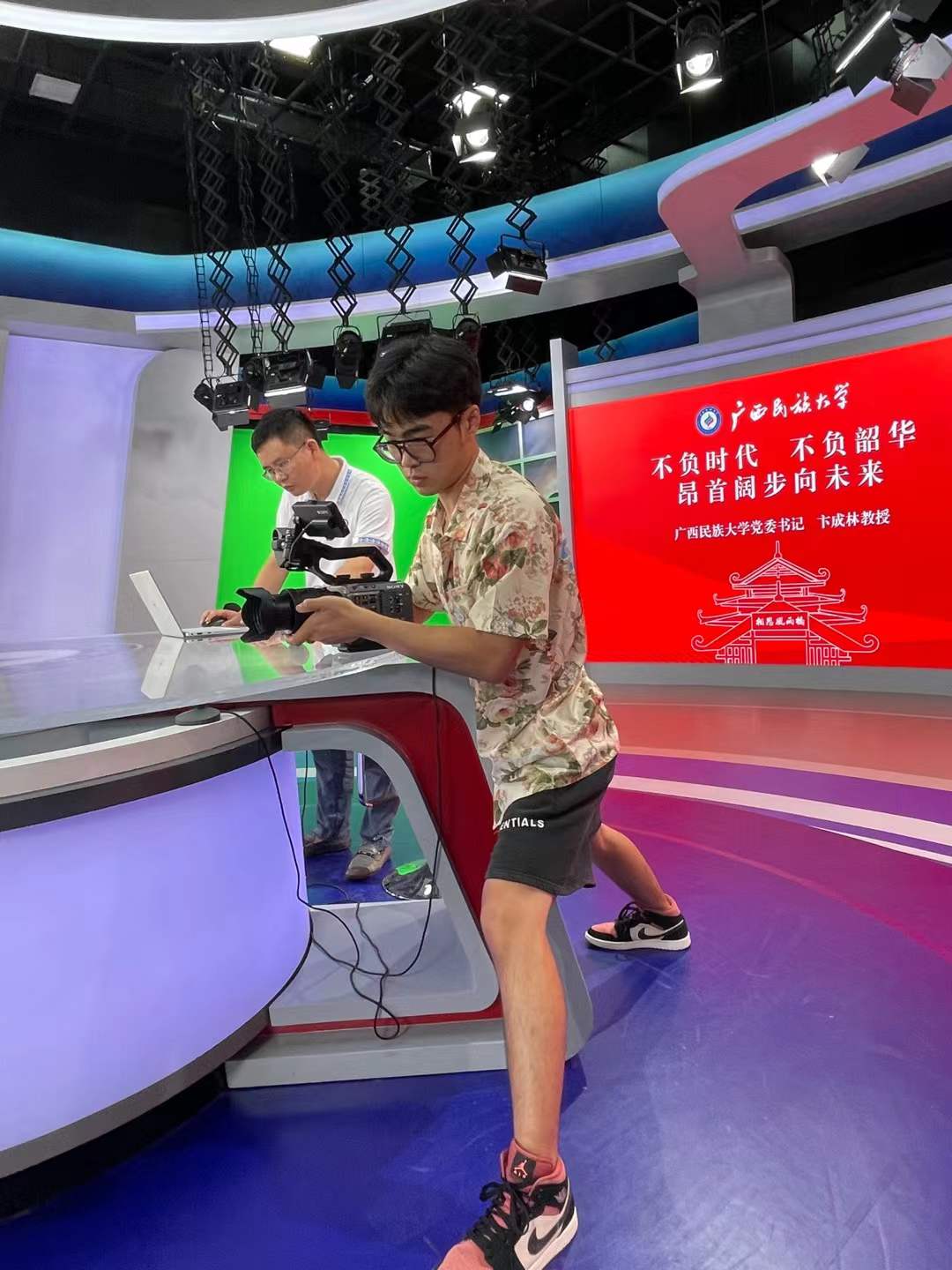 Students filming on-site video at Guangxi Minzu University